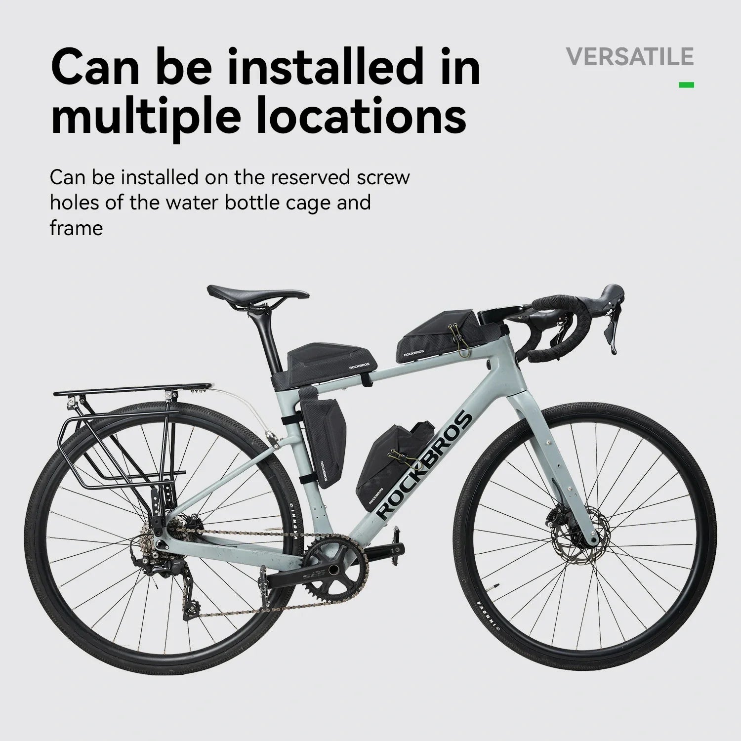 A light gray Rockros road bicycle shown on a pale gray background with marketing text stating it can be installed in multiple locations on the bottle cage and frame.
