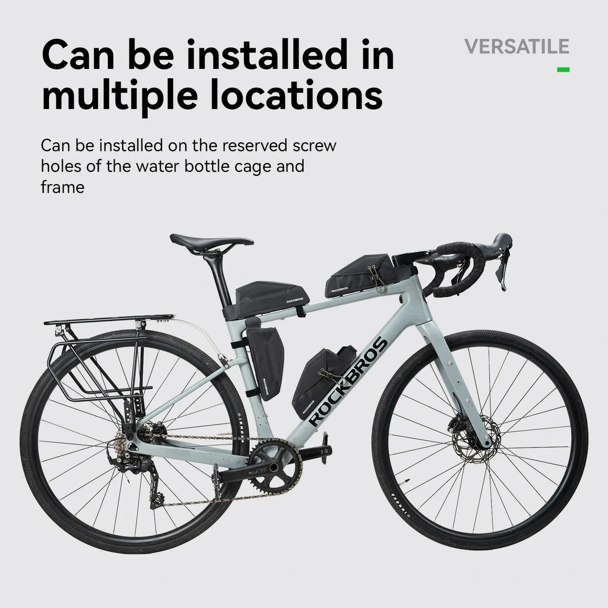 A light gray Rockros road bicycle shown on a pale gray background with marketing text stating it can be installed in multiple locations on the bottle cage and frame.