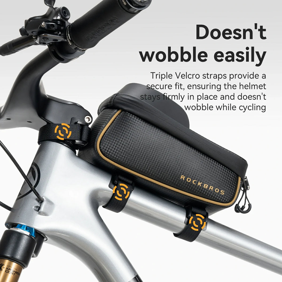 A black Rockbros bicycle bag mounted on a silver bicycle frame, with text overlay explaining its secure fit and wobble prevention.
