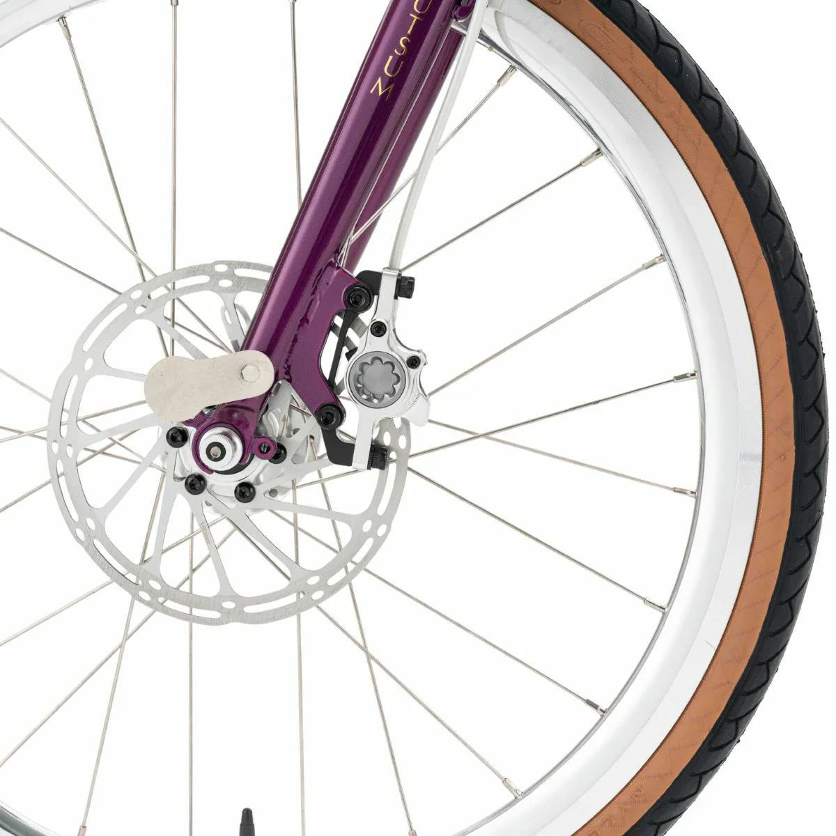 Close-up of a bicycle wheel with purple frame and brown tire on a white background #Color_Purple