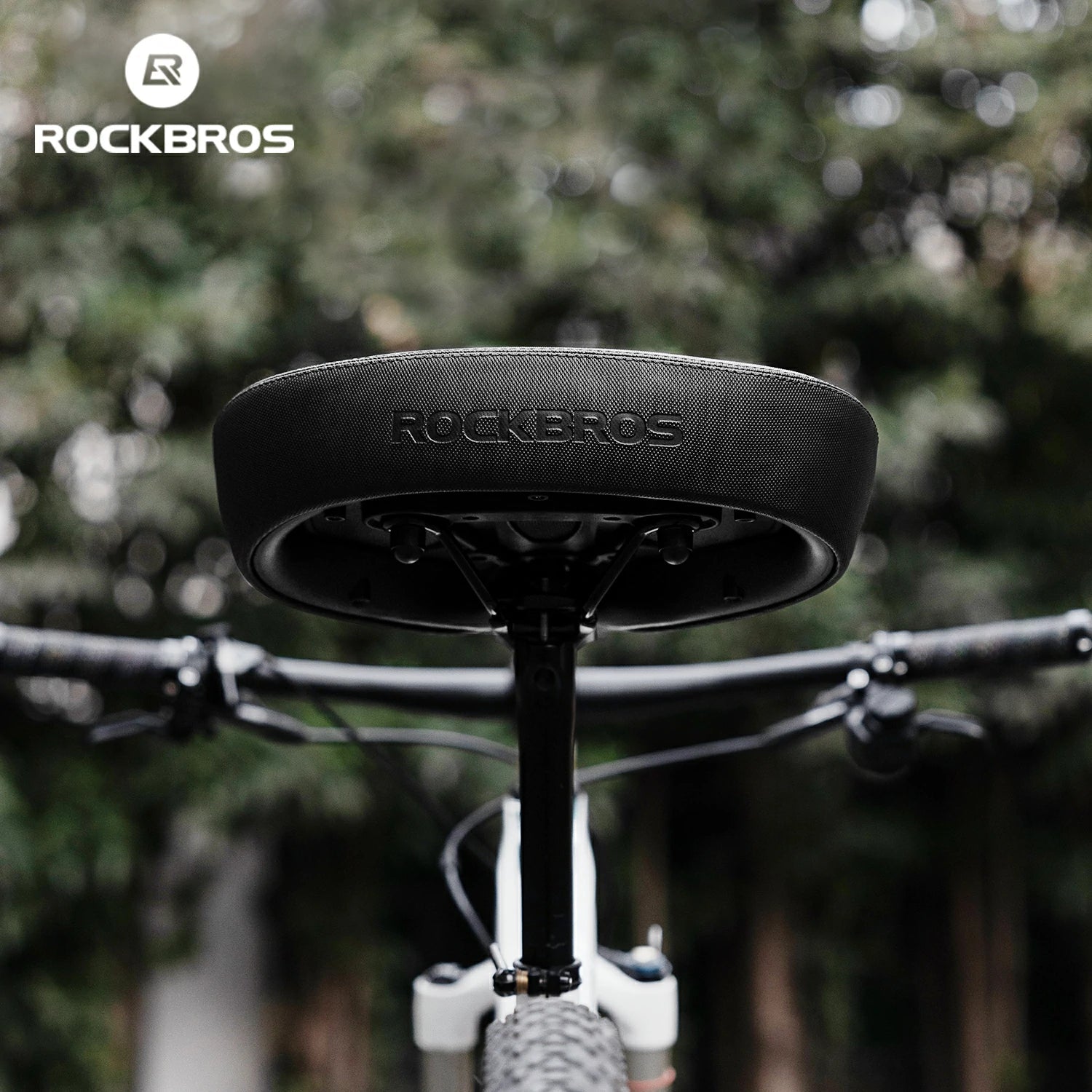 Close-up of a bicycle seat with 'RockBros' branding against a blurred green background