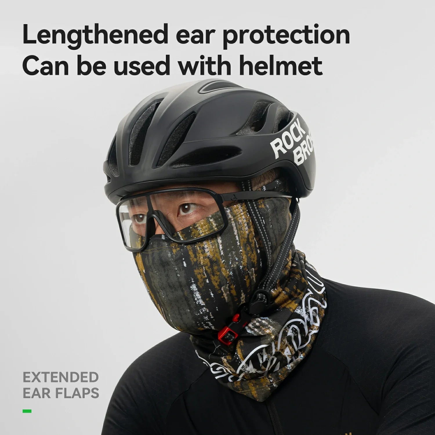 Person wearing a helmet with extended ear flaps and a face mask on a gray background