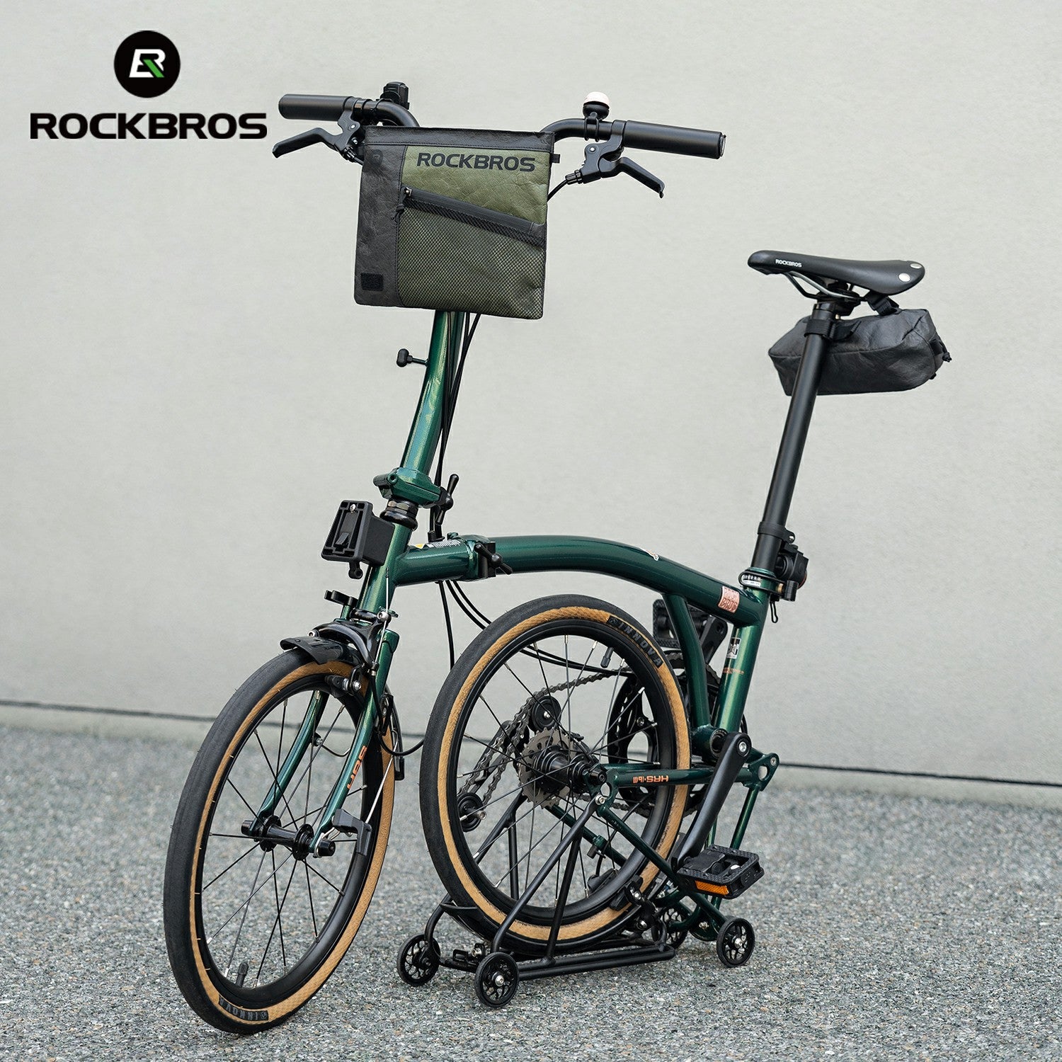 Green folding bike with storage bags on a gray background, featuring the RockBros brand.
