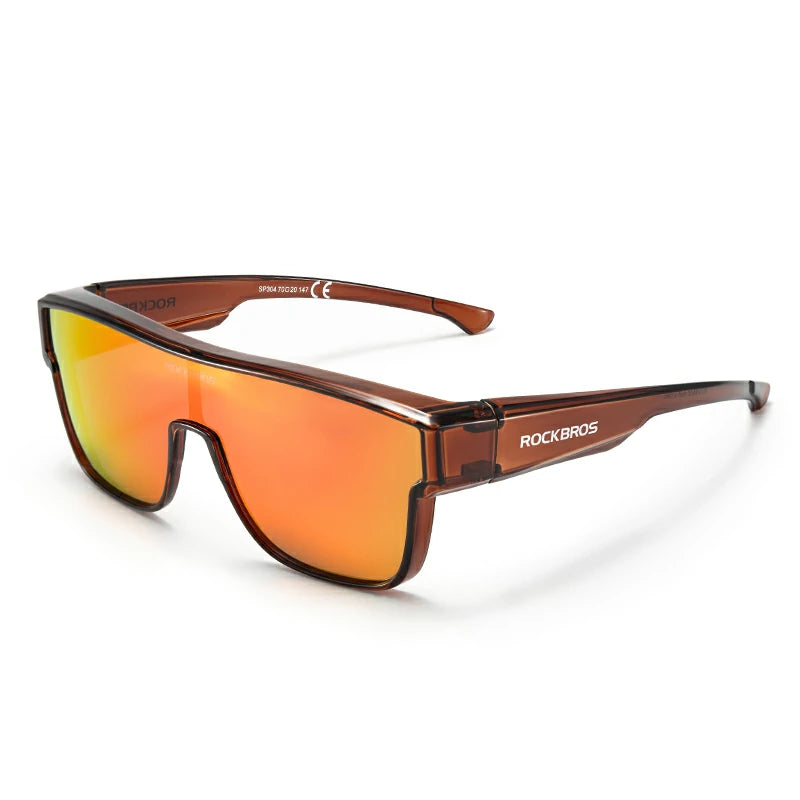 Rockbros shield-style sunglasses with a translucent brown frame and mirrored orange-to-yellow lenses, shown on a clean white background. #Color_Dark Brown