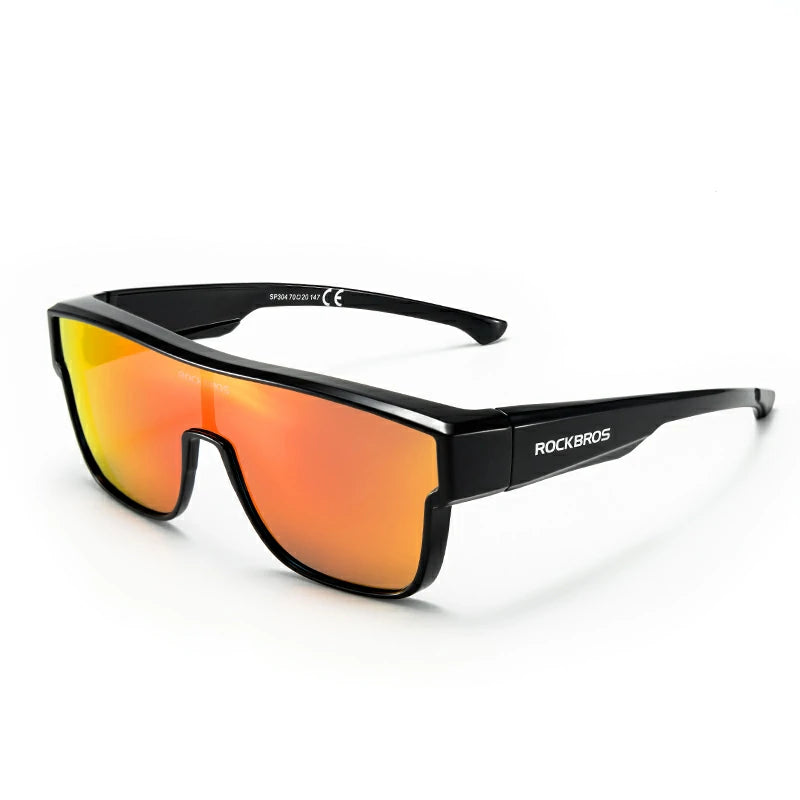 Black wrap-around sunglasses with a vibrant orange-to-yellow mirrored lens, featuring the ROCKBROS brand name on the temple arm, set against a plain white background. #Color_Dark Black