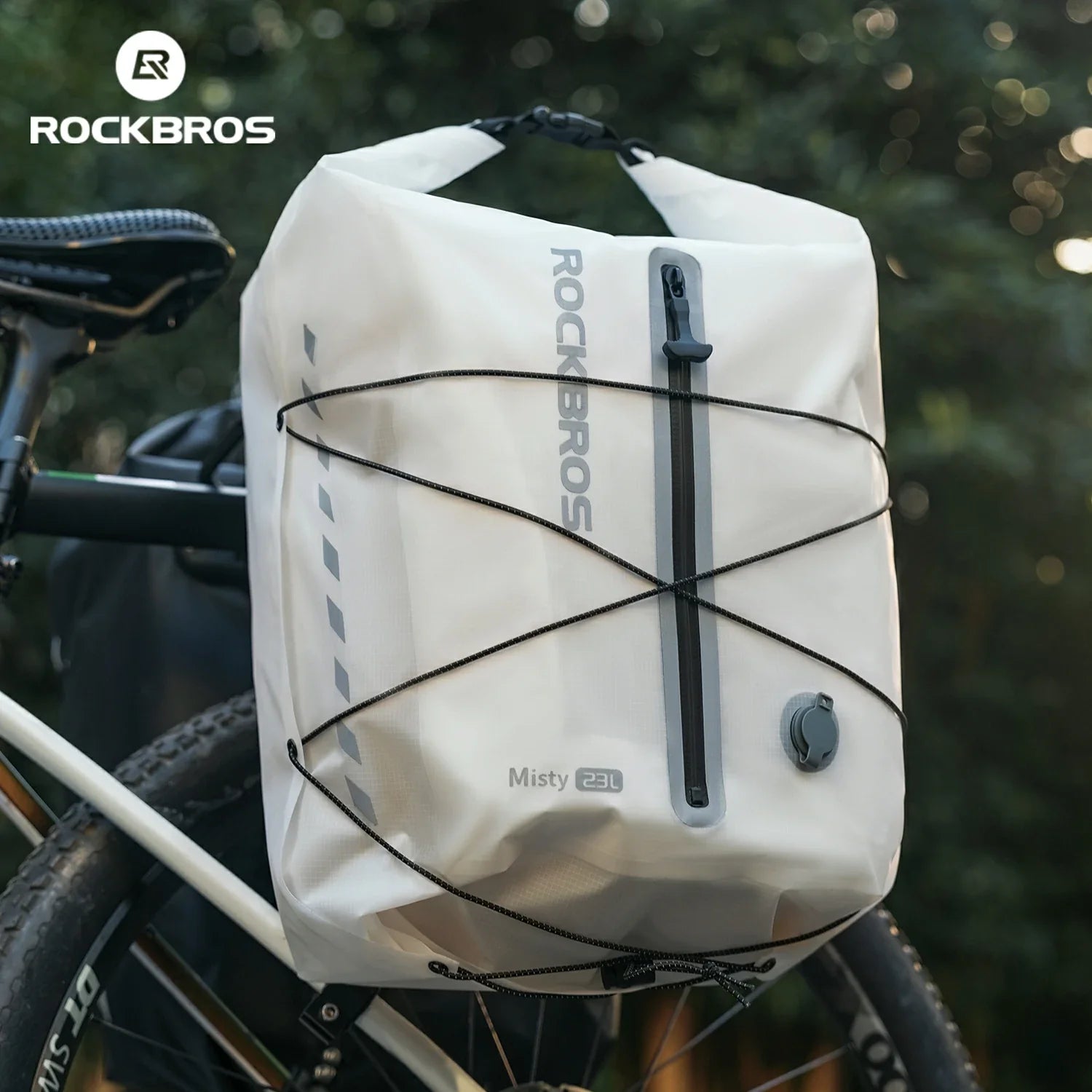 White bicycle saddle bag with 'RockBros' branding attached to a bike, set against a blurred natural background. #color_white