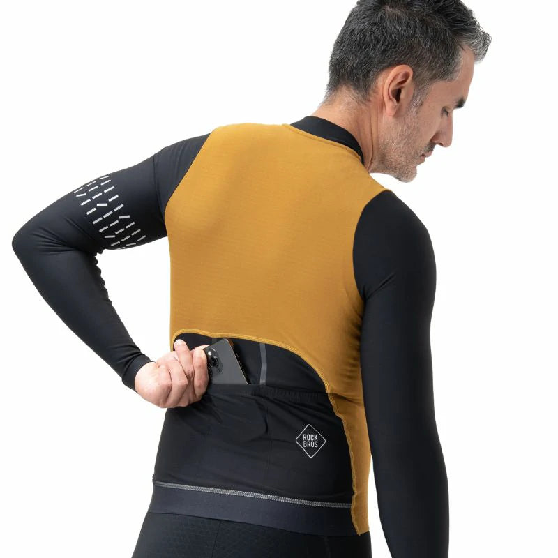 Man wearing a mustard yellow and black long-sleeve cycling jersey on a white background #color_Brown