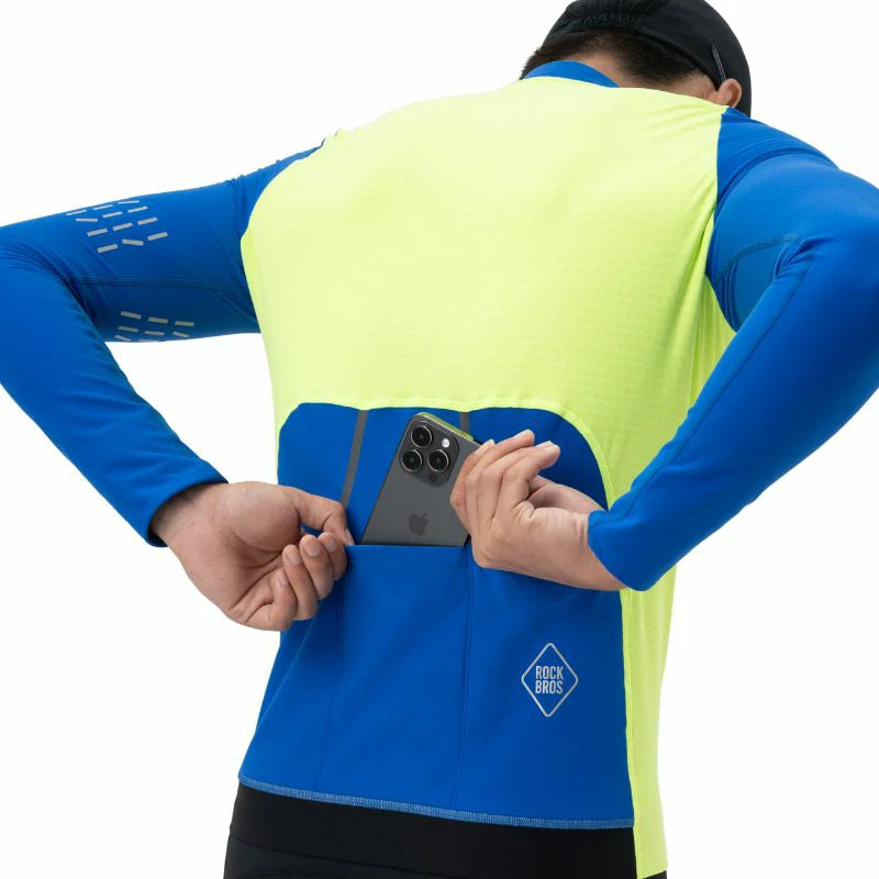 Person wearing a blue and yellow athletic outfit with a phone in the pocket, on a white background. #color_Yellow
