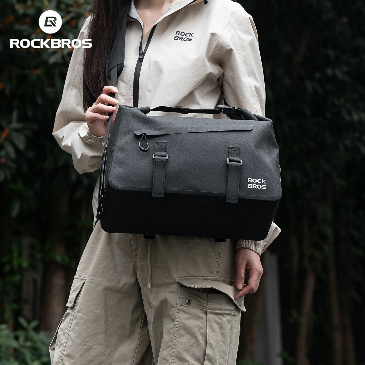 Person holding a black bag with 'Rock Bros' branding against a dark background #color_black