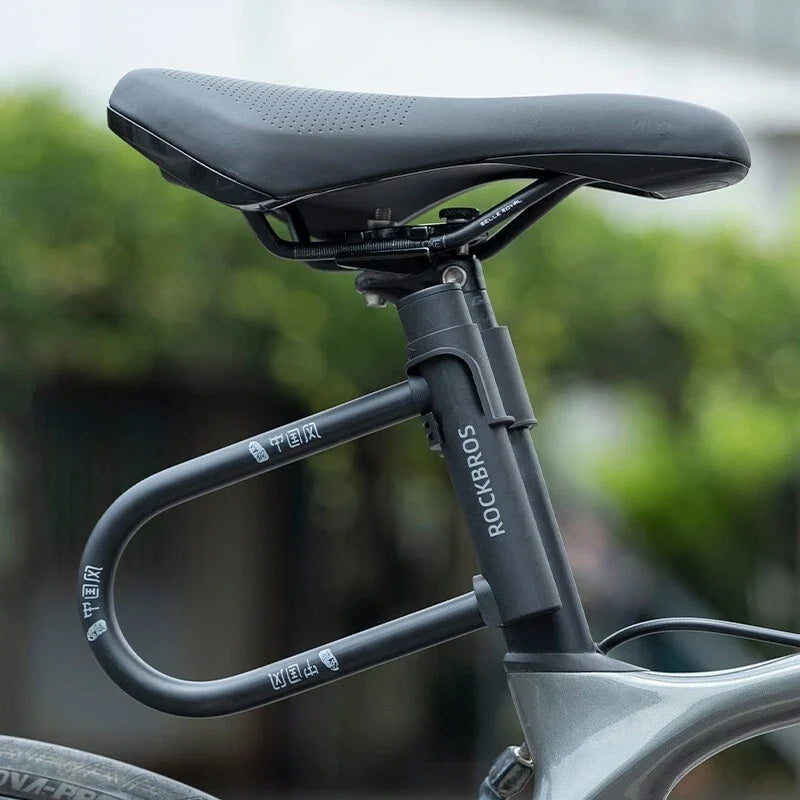 Bicycle seat post with 'ROCKBROS' branding against a blurred green background