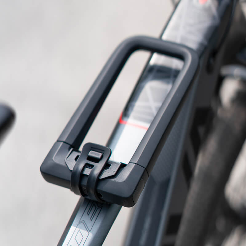 Close-up of a black bicycle handlebar with a blurred background