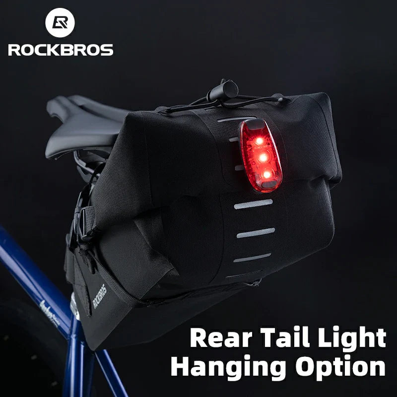Black bicycle tail light bag with red light on a dark background, featuring RockBros branding.