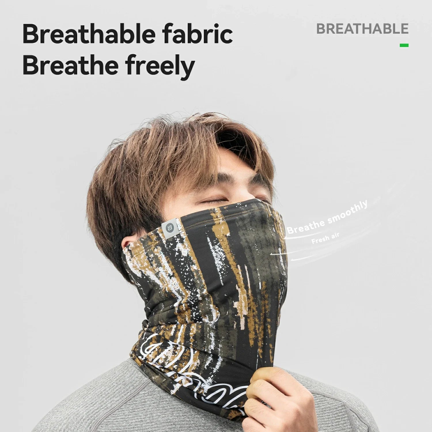 Person wearing a breathable fabric face mask with text on a gray background