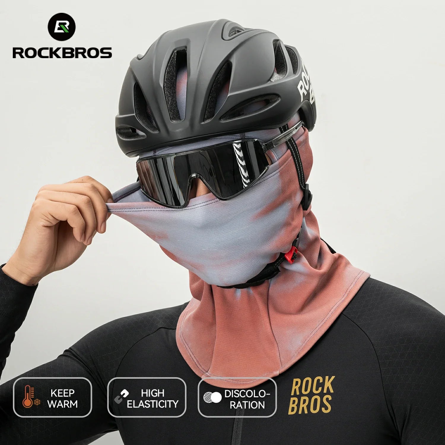 Person wearing a black helmet and pink neck gaiter with ROCKBROS branding on a gray background. 