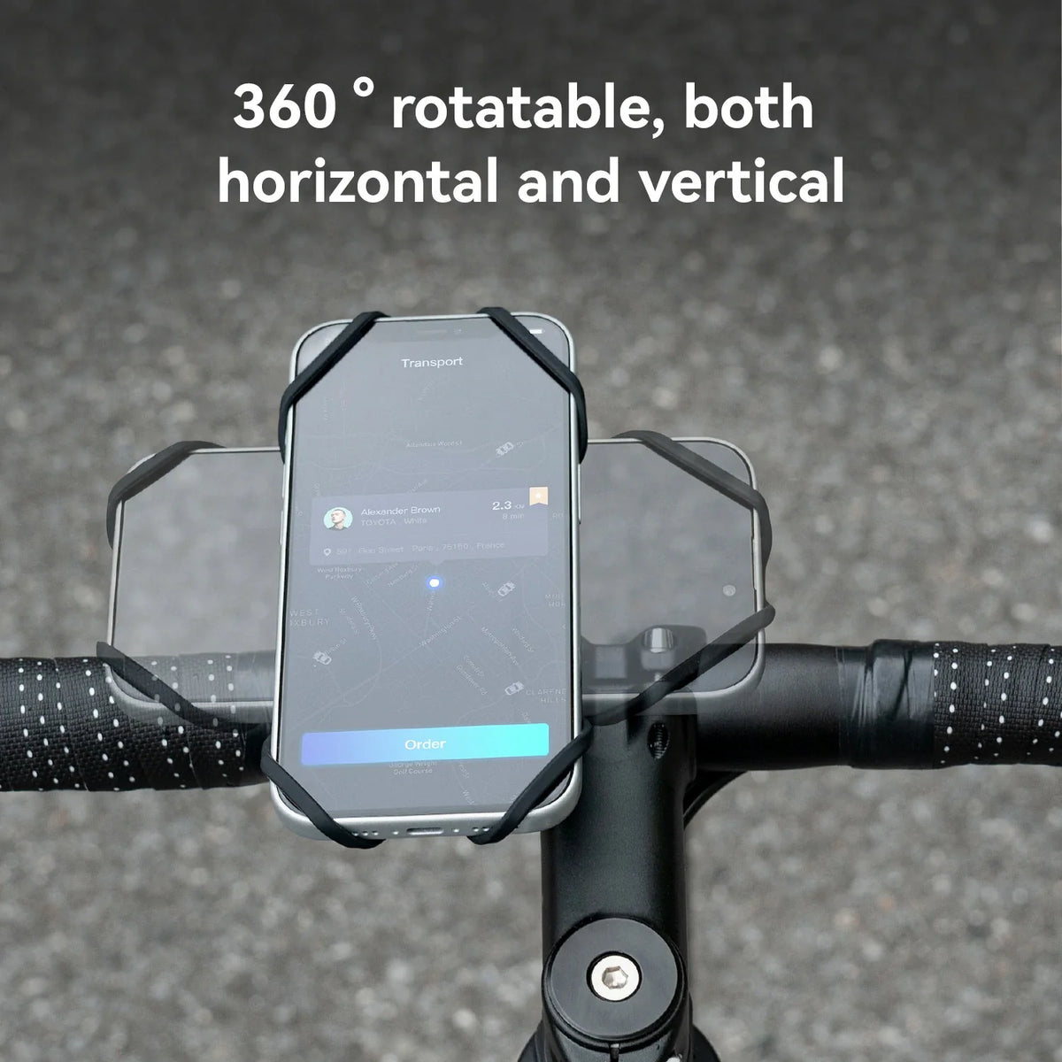 A black bicycle handlebar phone mount holding a smartphone, shown outdoors on a road with white text reading '360° rotatable, both horizontal and vertical'.