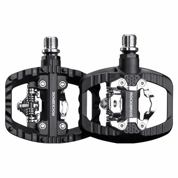 Black bicycle pedals with metallic components on a white background