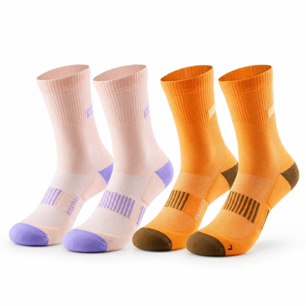 Four athletic crew socks arranged in two pairs on a white background. The left pair is light peach with lavender accents, and the right pair is bright orange with brown and dark orange accents. #Color_orange+pink