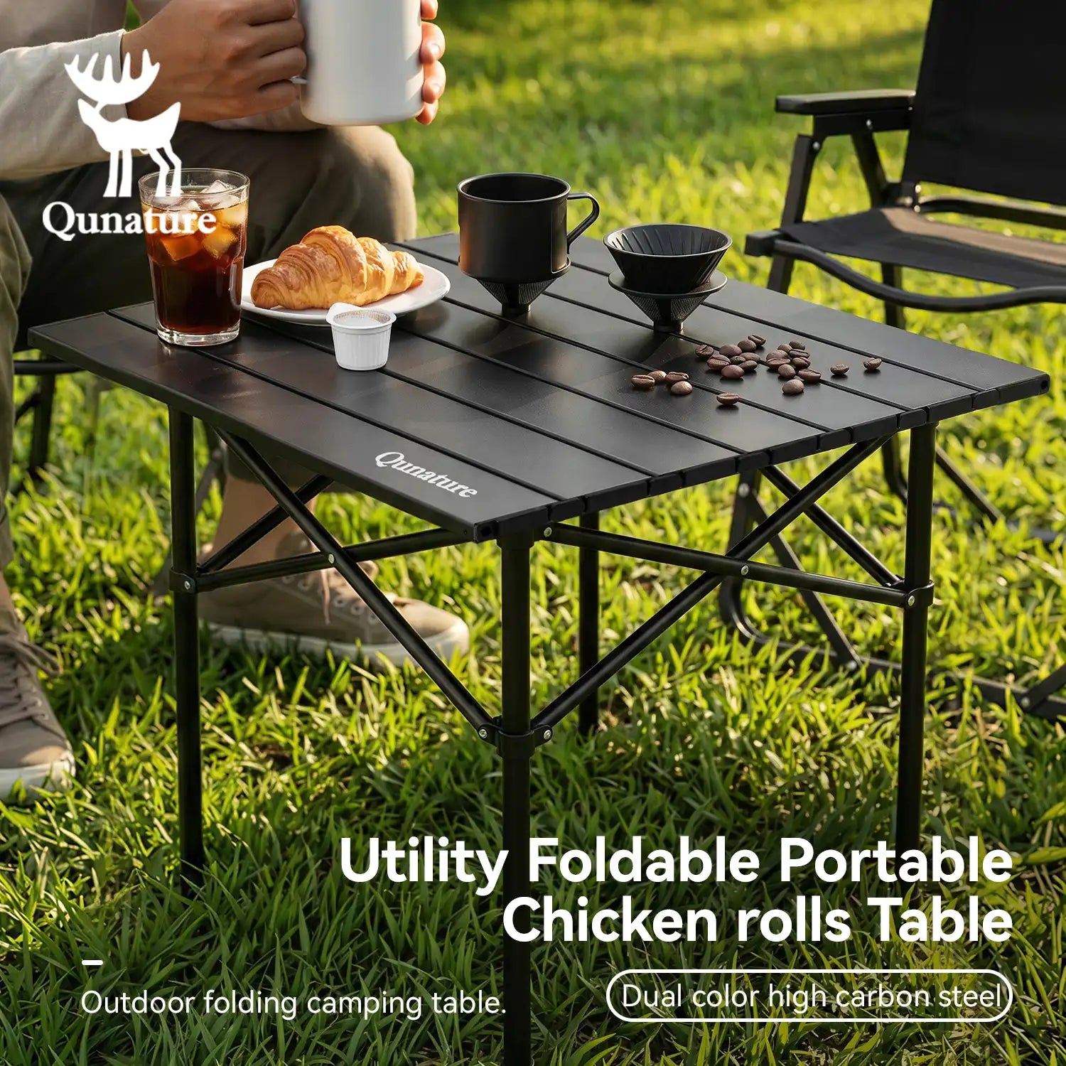 Portable folding camping table with food and drinks on a grassy outdoor setting, featuring the Qunature brand.