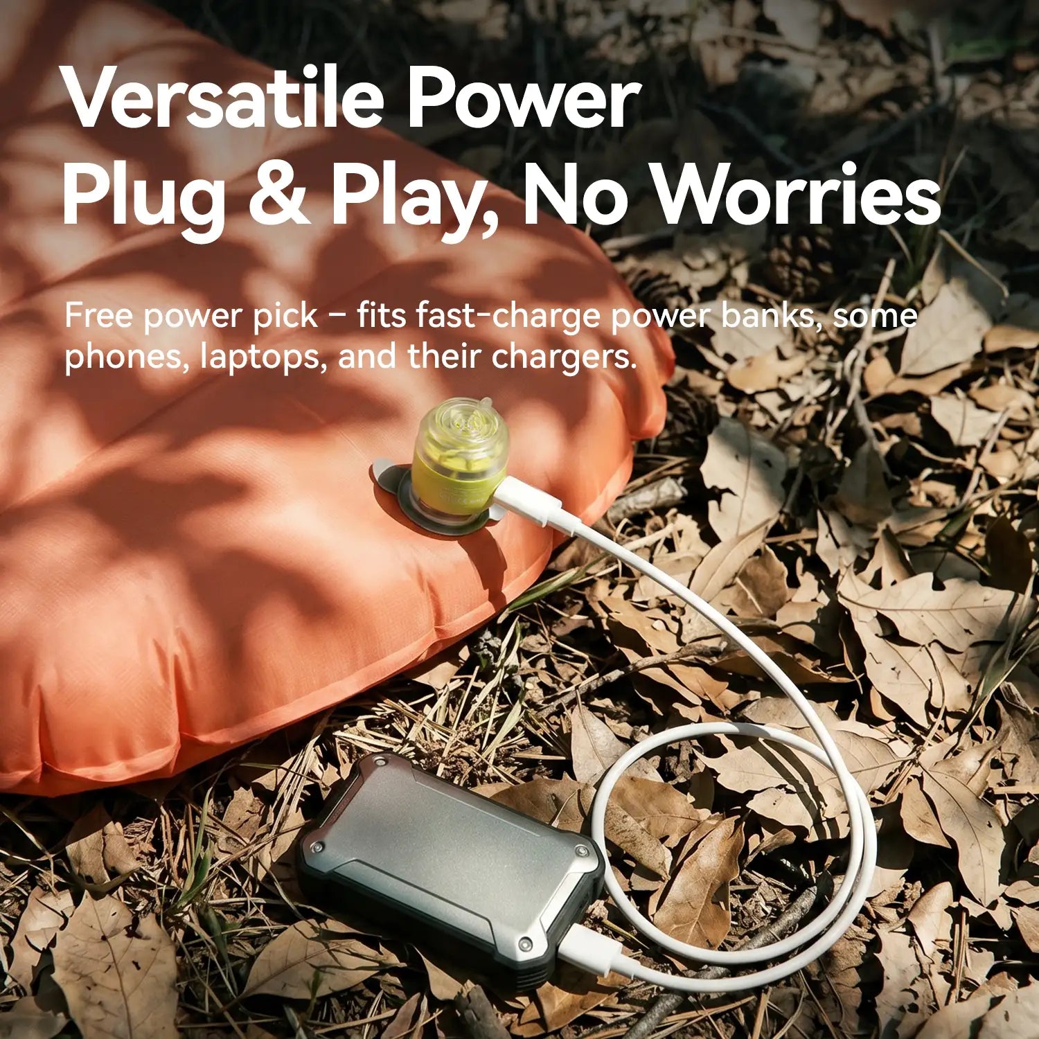 Power bank with USB cable on leaves, text about versatile power plug and play.
