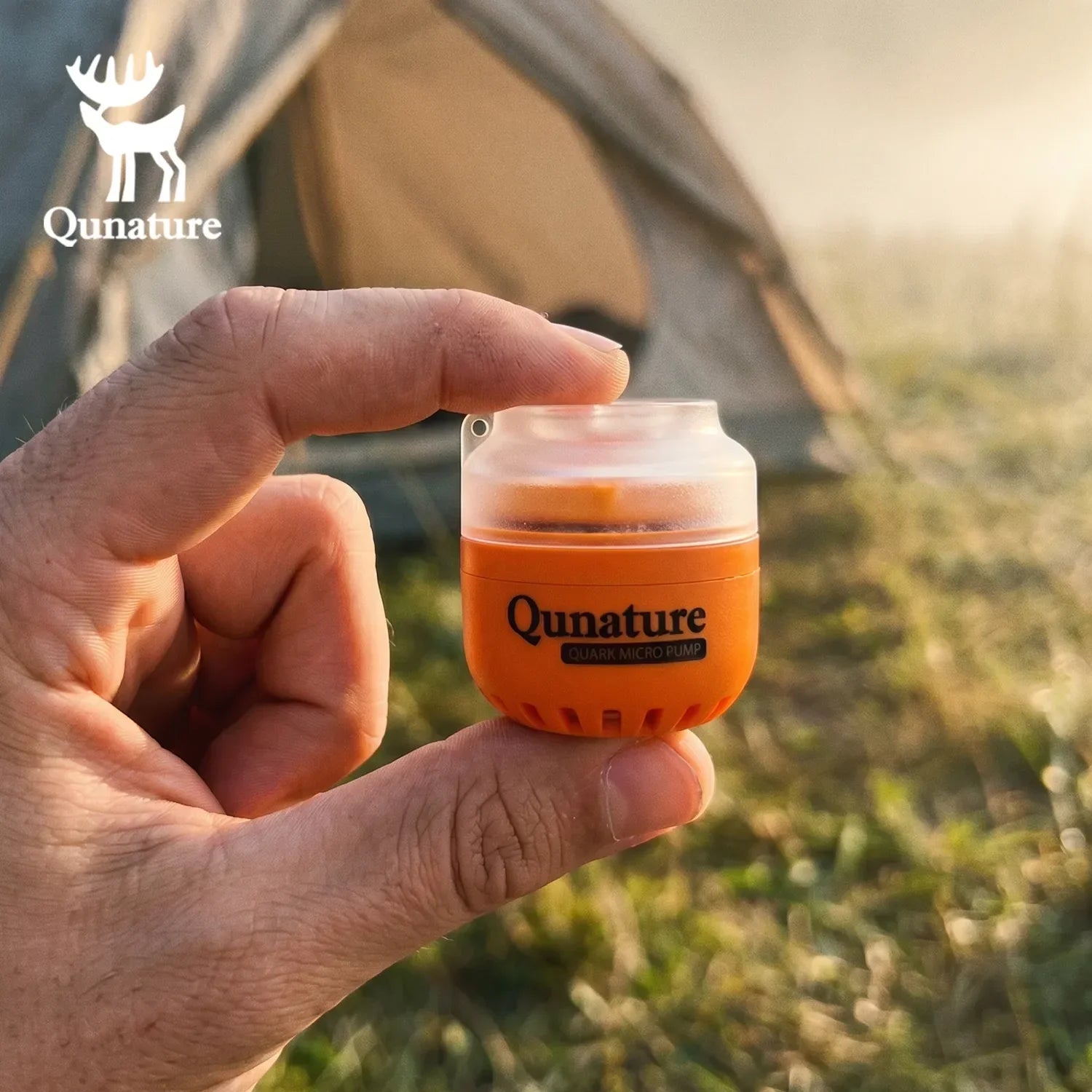 Hand holding a Qunature product with a camping background