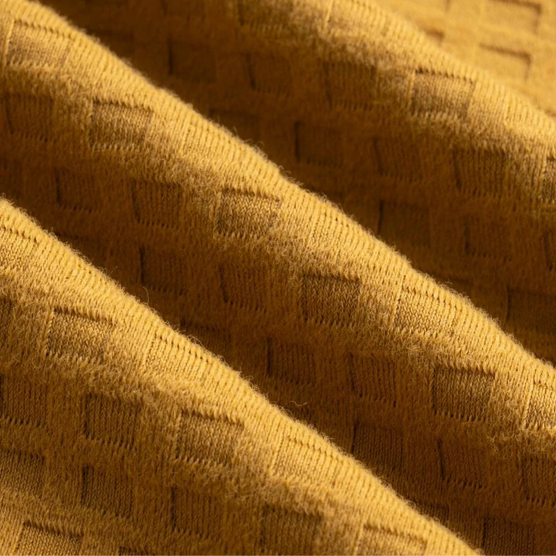 Close-up of textured yellow fabric with a subtle pattern #color_Brown